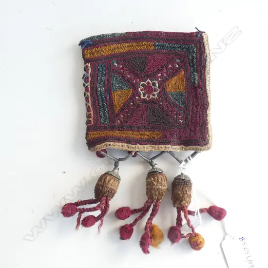 A small Afghan embroidered bag with three tassels,